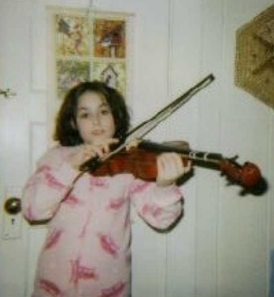 Talia playing the fiddle in Montana in 2000