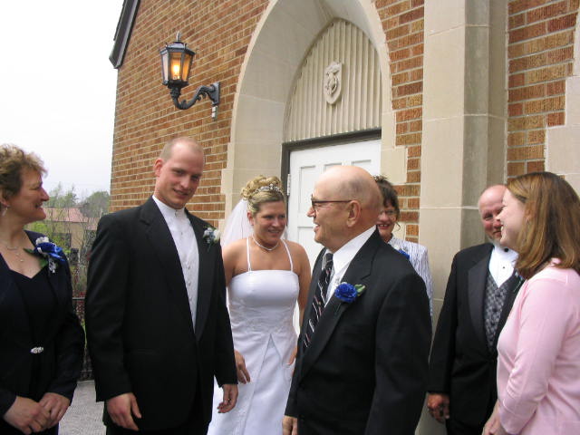 Grandpa John Knuth laughs with the newly weds