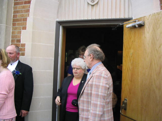 Gloria Goller and Erv Goller exit the church