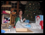 Kelly under the Christmas Tree with all her gifts