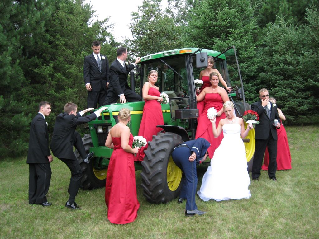 Bridal party climb a tractor