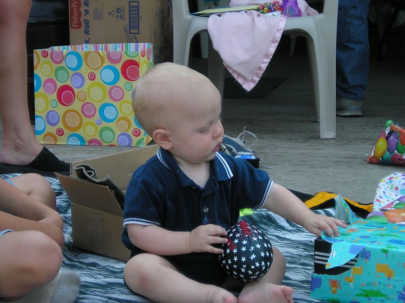 Playing with gifts on a first birthday party