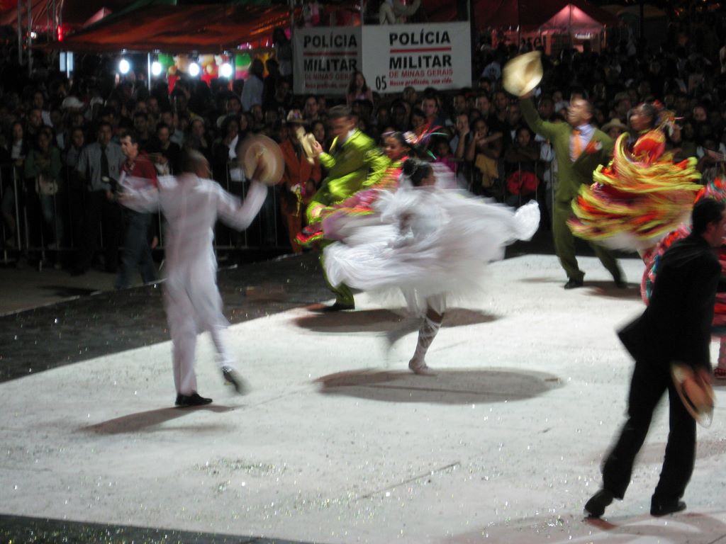 Brazilian fold dancers twirl below the police