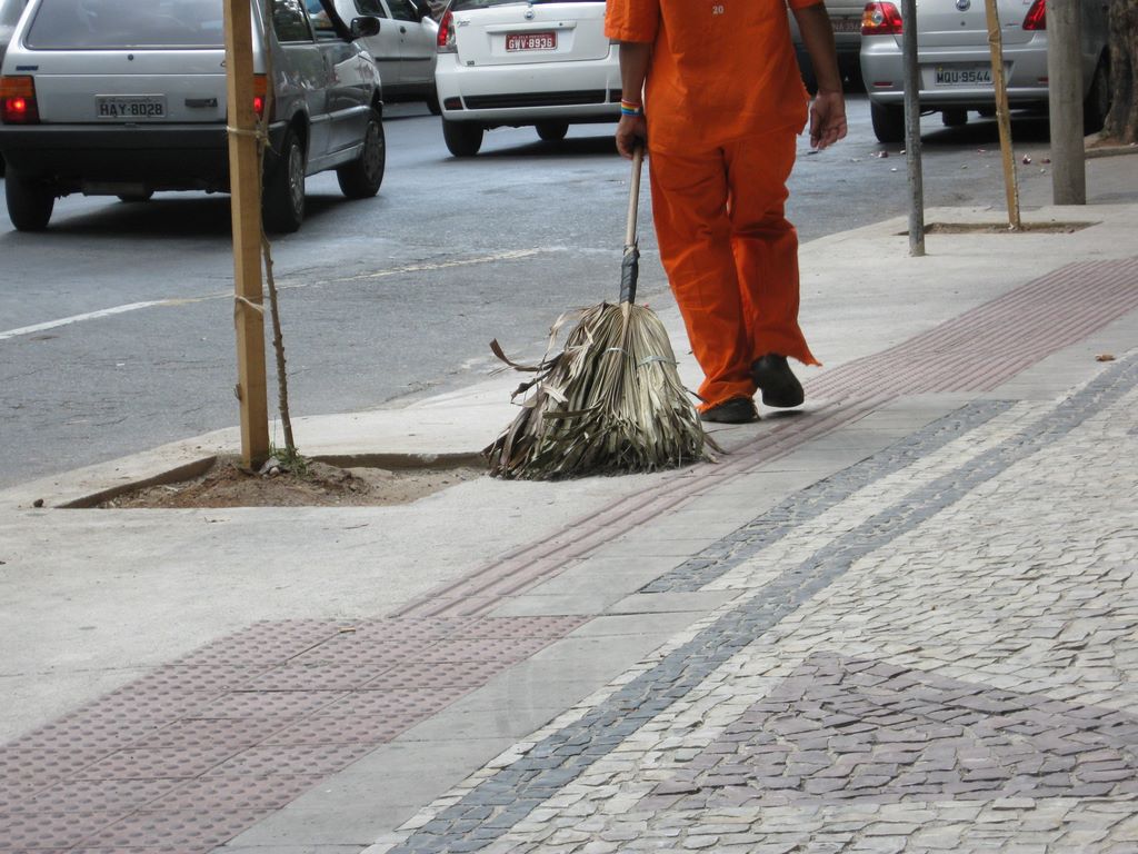 Brazilian street sweeper with a broom made of palm fronds