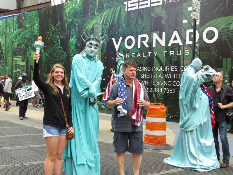 Posing with the Statue of Liberty