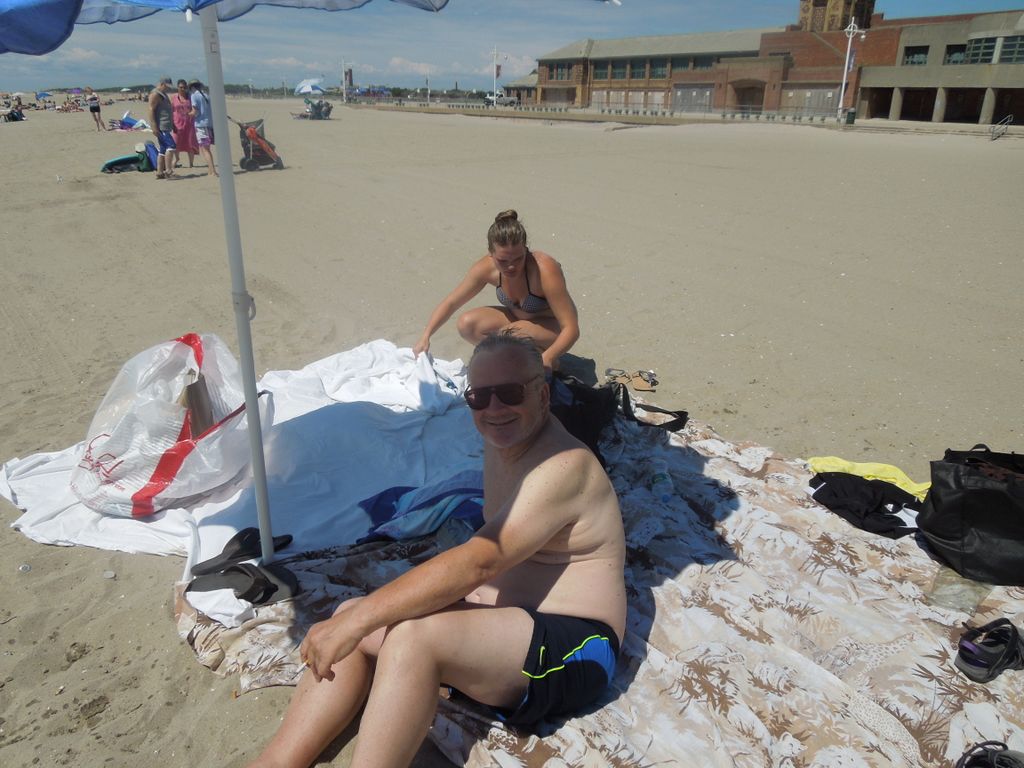 Dennis Knuth and Kelsey under the beach umbrella