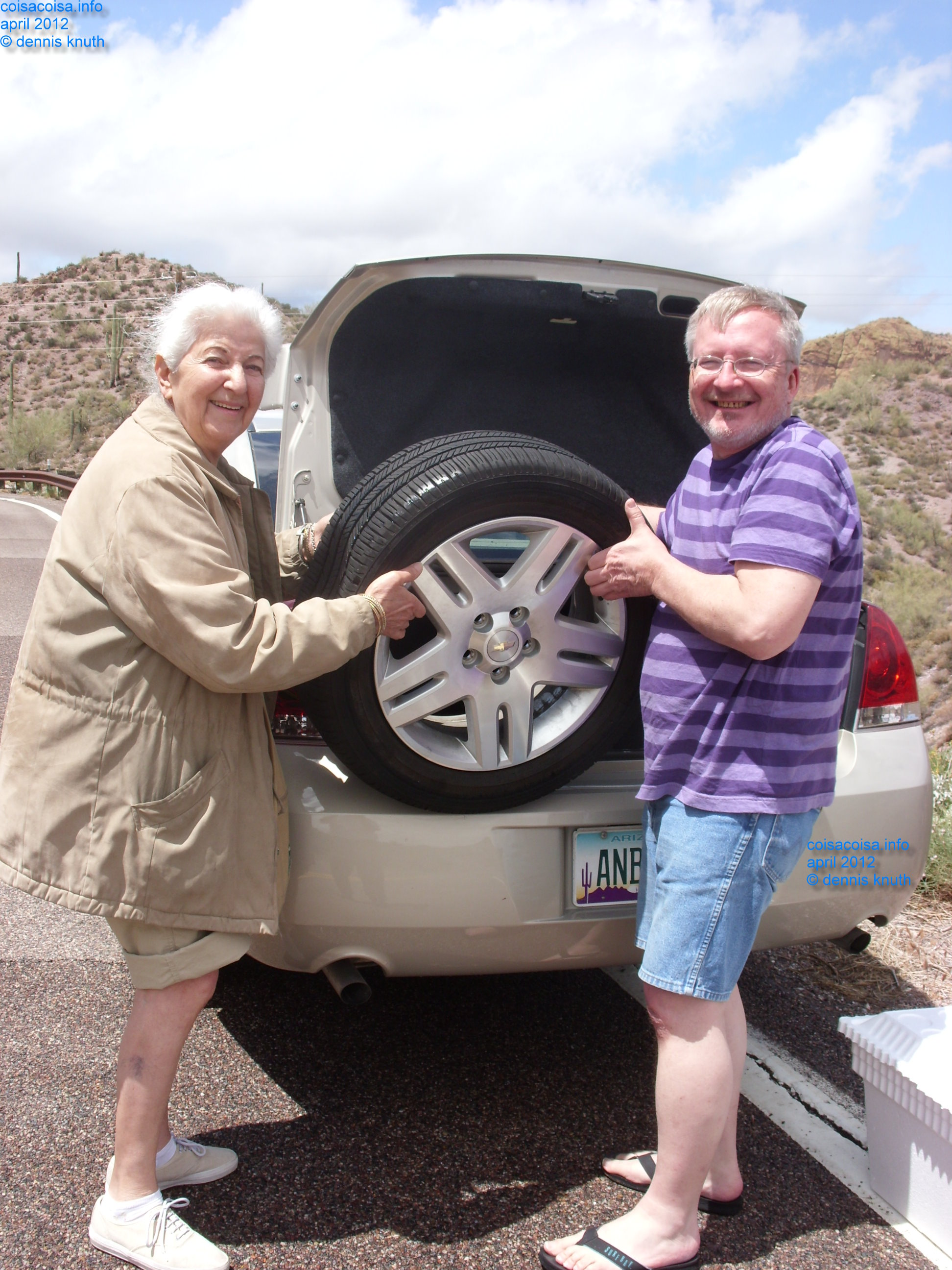 Dennis Knuth and Stella get the spare tire out of the trunk