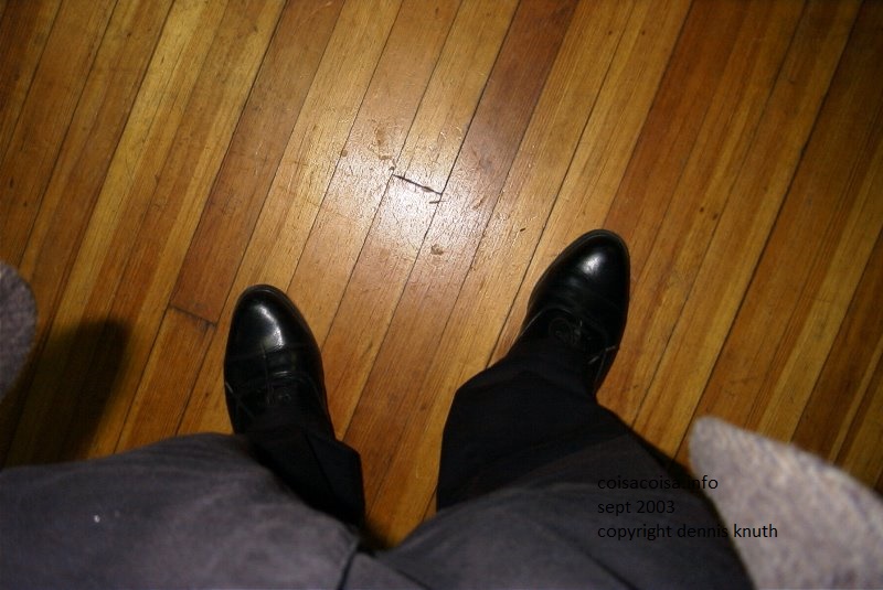 Mens feet in shoes on a wooden church floor