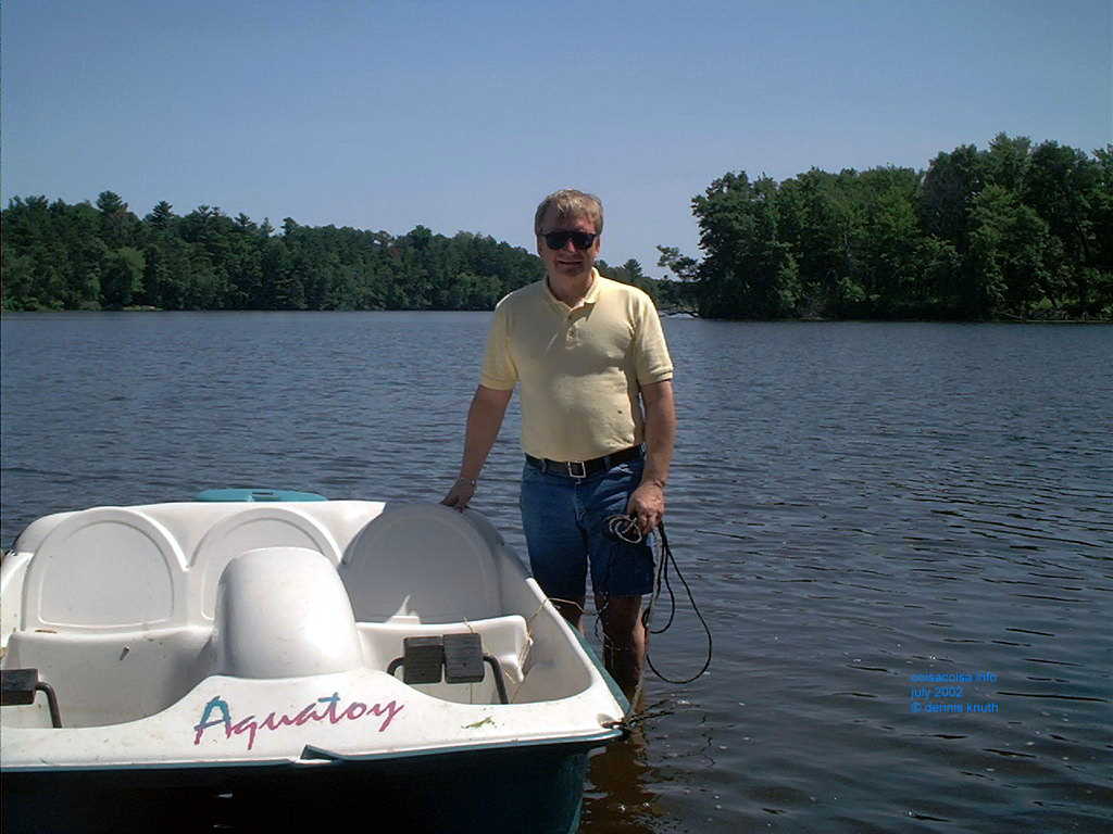 Dennis on the Dells Pond with a 	Paddle Boad