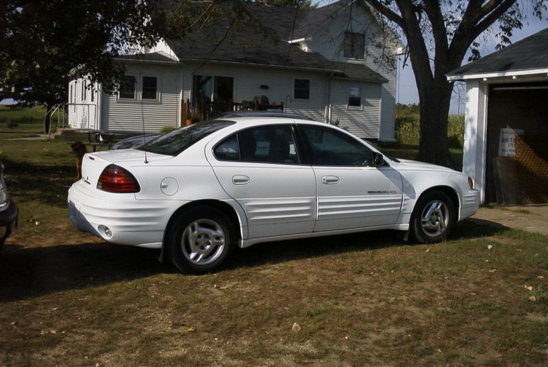 Justins Pontiac with the old farmhouse