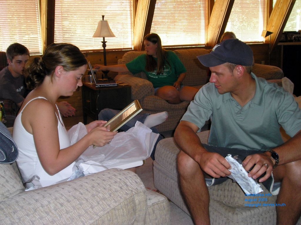 Justin looks on as Julia reads a plaque