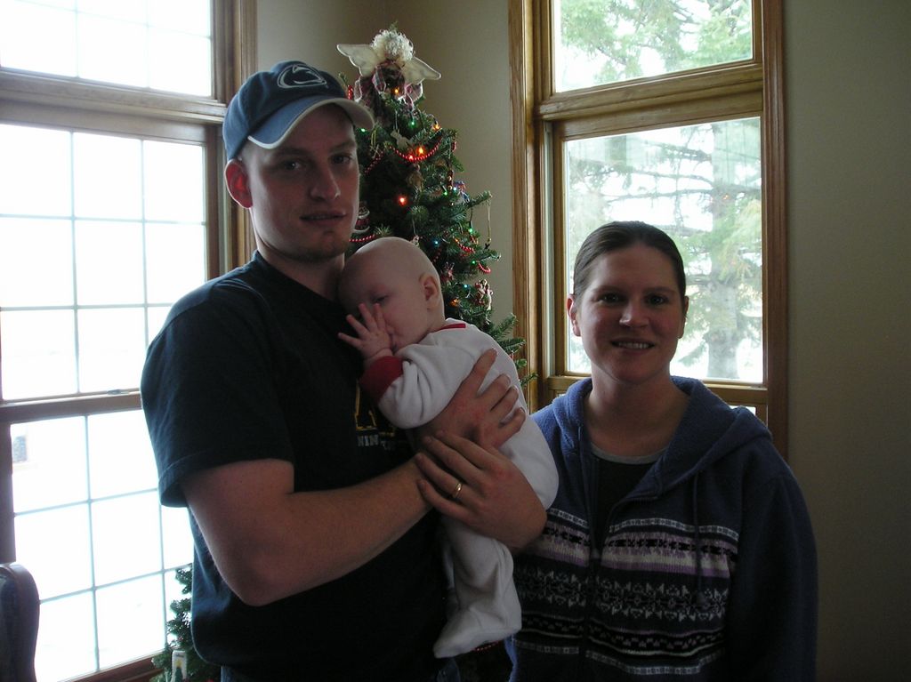 Father and Mother Nathan and Kelly Moore with Jared on his first Christmas