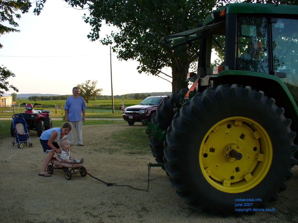 Tractor pulling the rusty red wagon