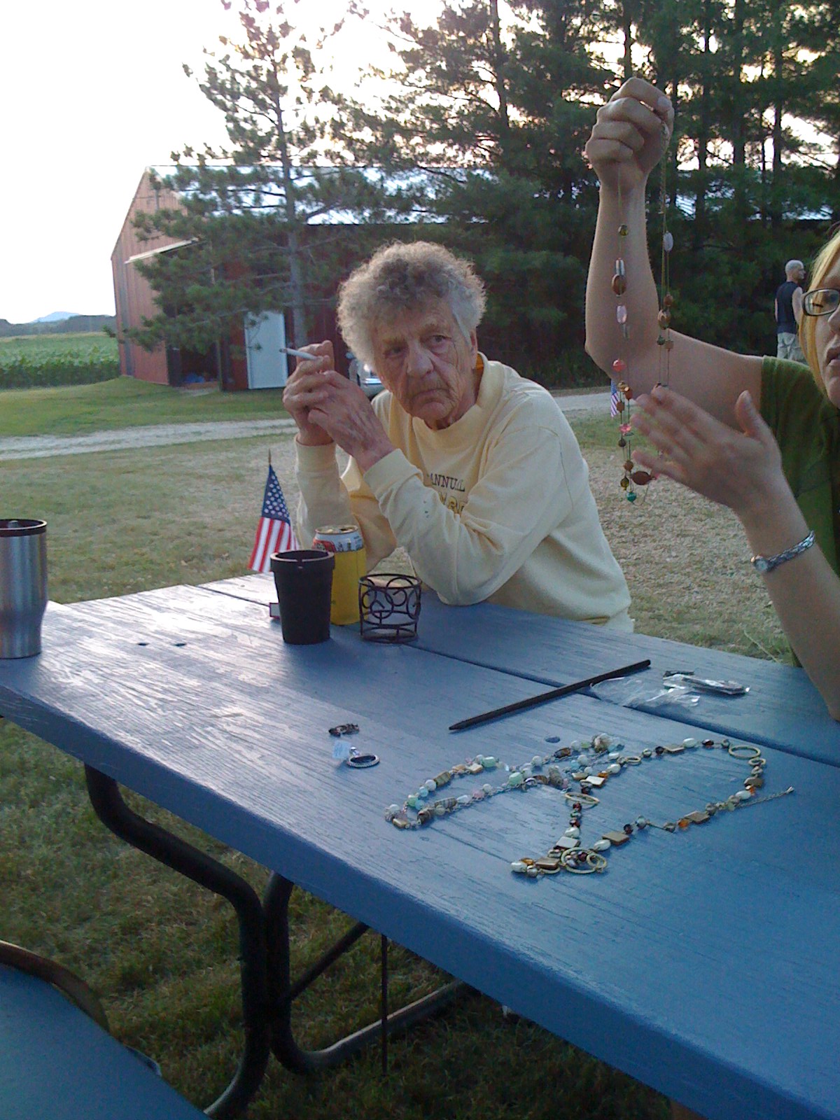 Emogene watching suspiciously as Kelli untangles jewelry