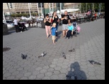 Family looking down at a smart phone