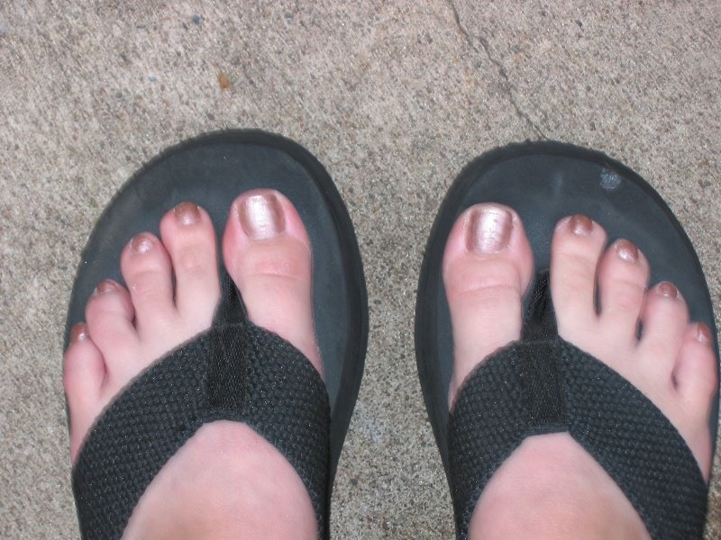 Woman's feet in sandals on a carpet